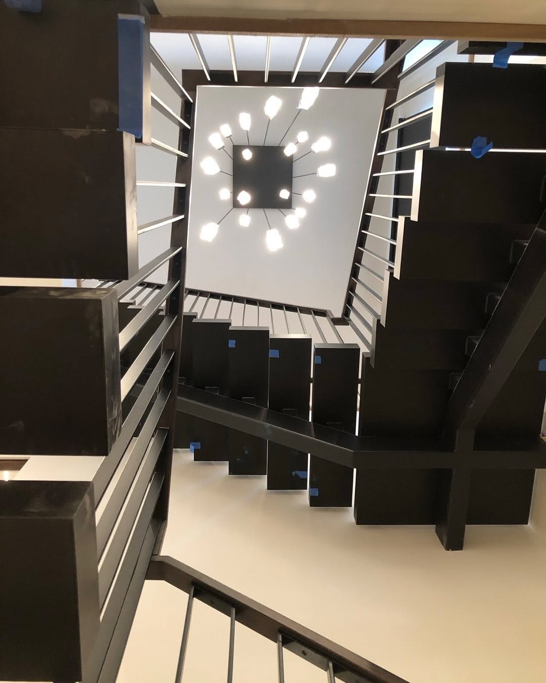 Multi-story steel staircase and railings, view from above